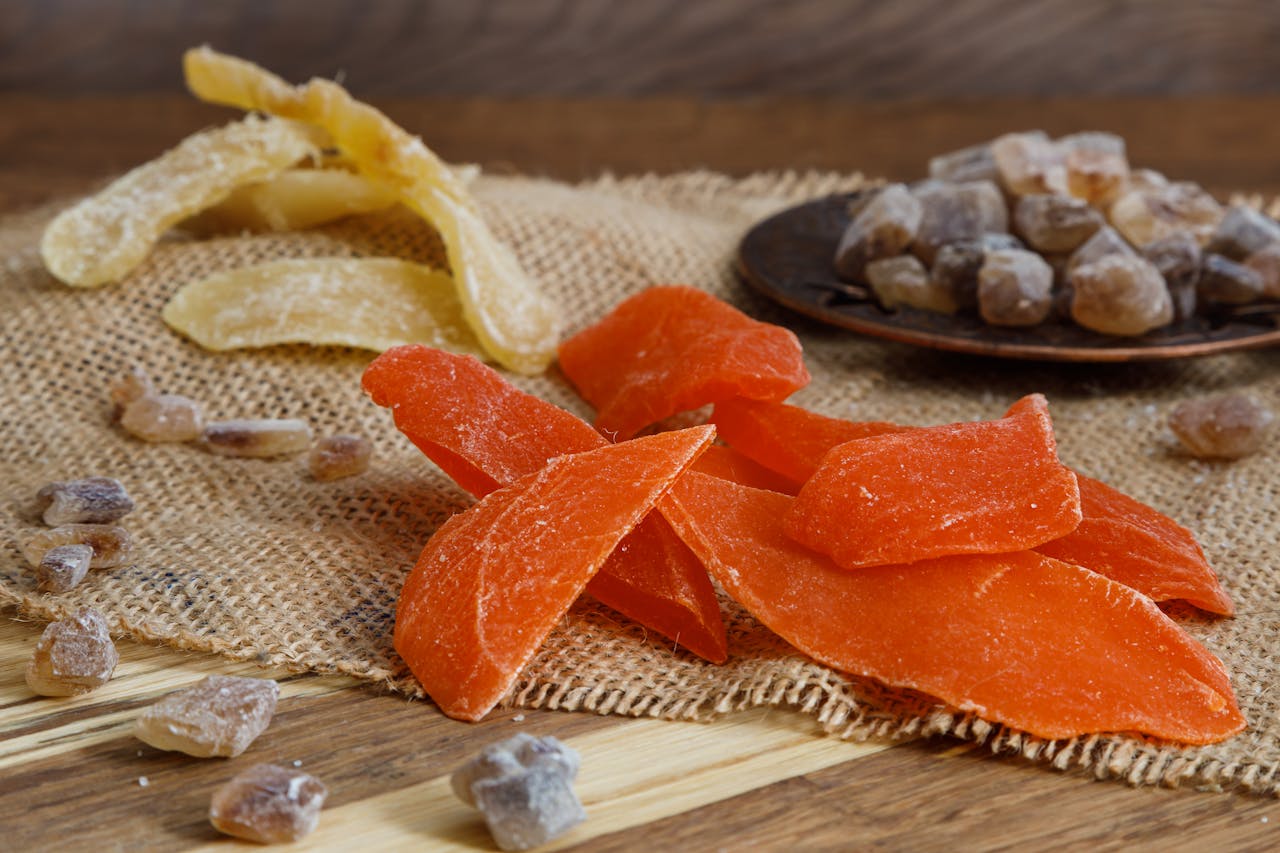 Vibrant dried fruits on burlap, showcasing natural textures and colors.